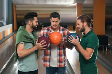 Photo of Group of men with balls in bowling club