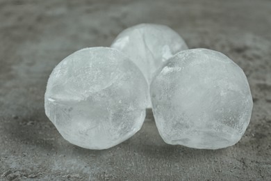 Photo of Frozen ice balls on grey table, closeup