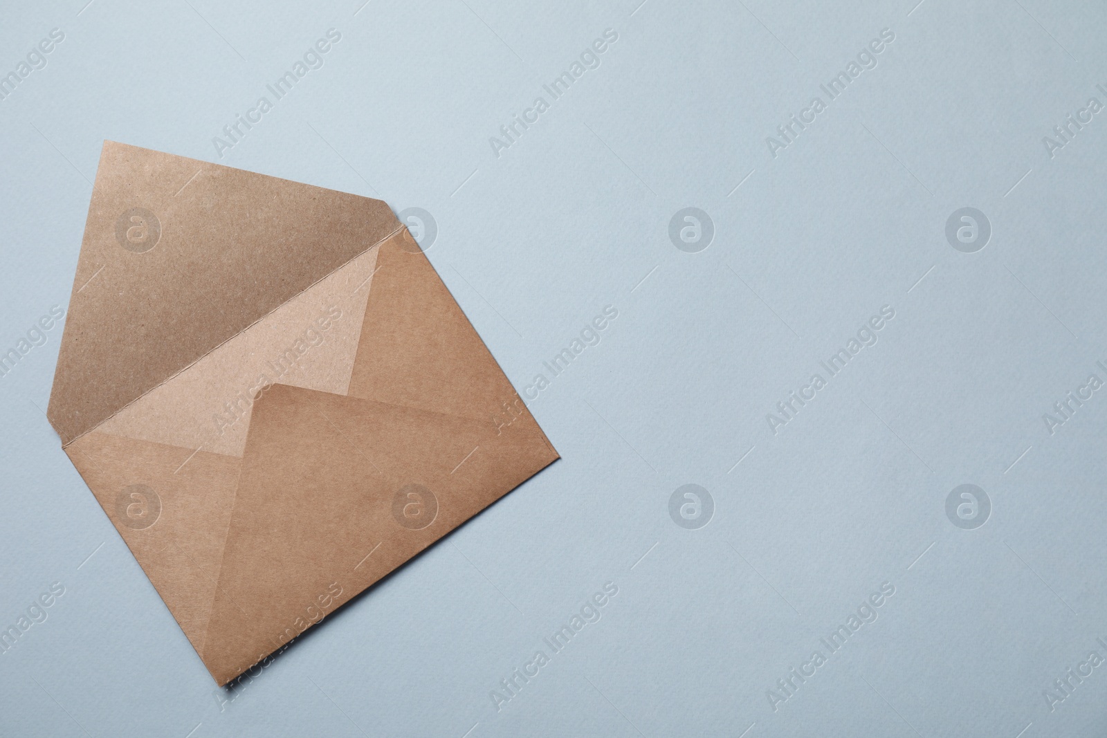 Photo of Letter envelope on grey background, top view. Space for text