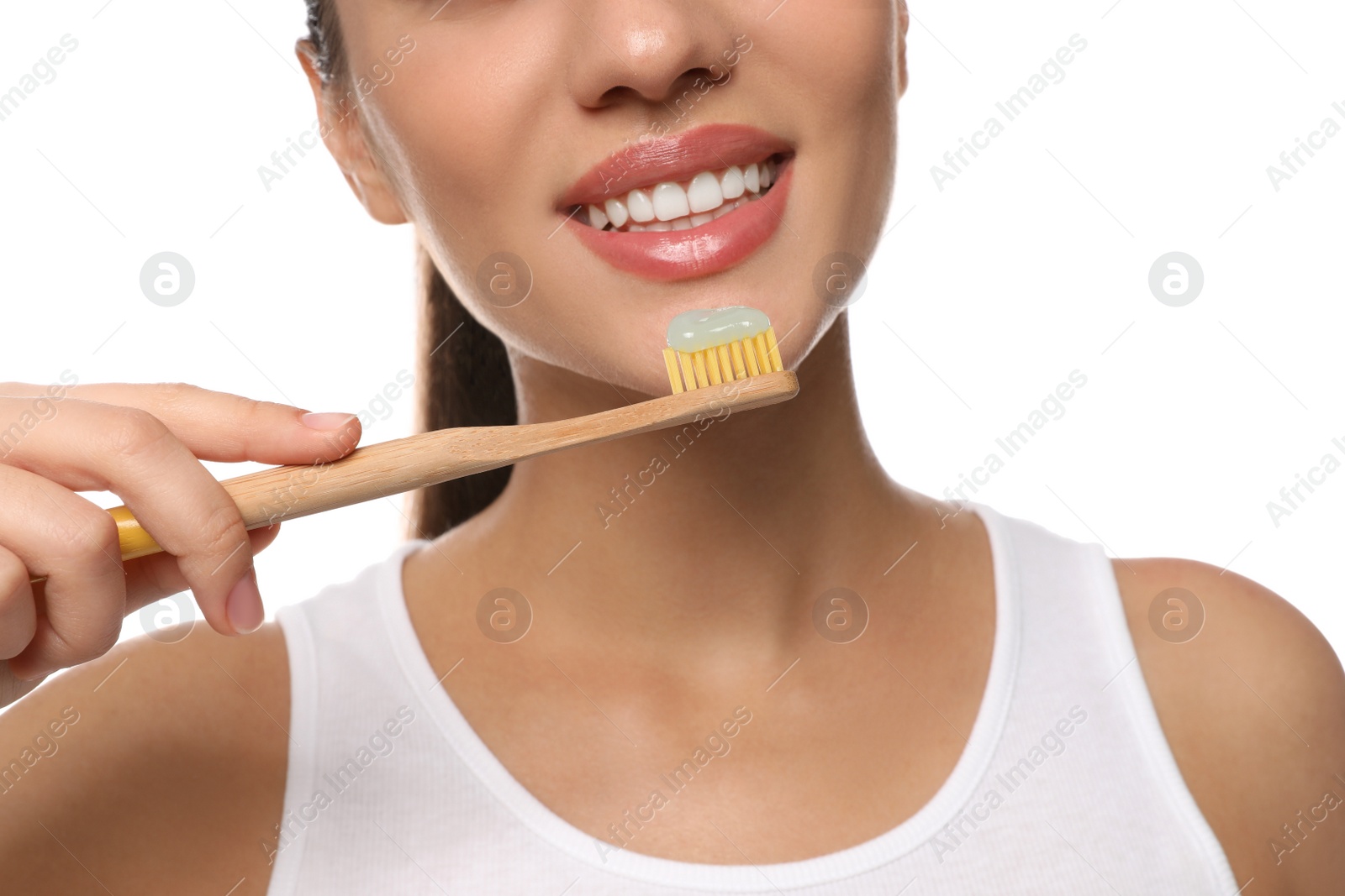 Photo of Woman holding toothbrush with paste on white background, closeup