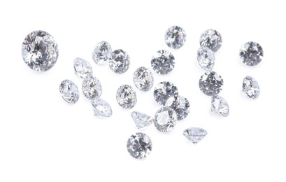 Photo of Many beautiful shiny diamonds on white background