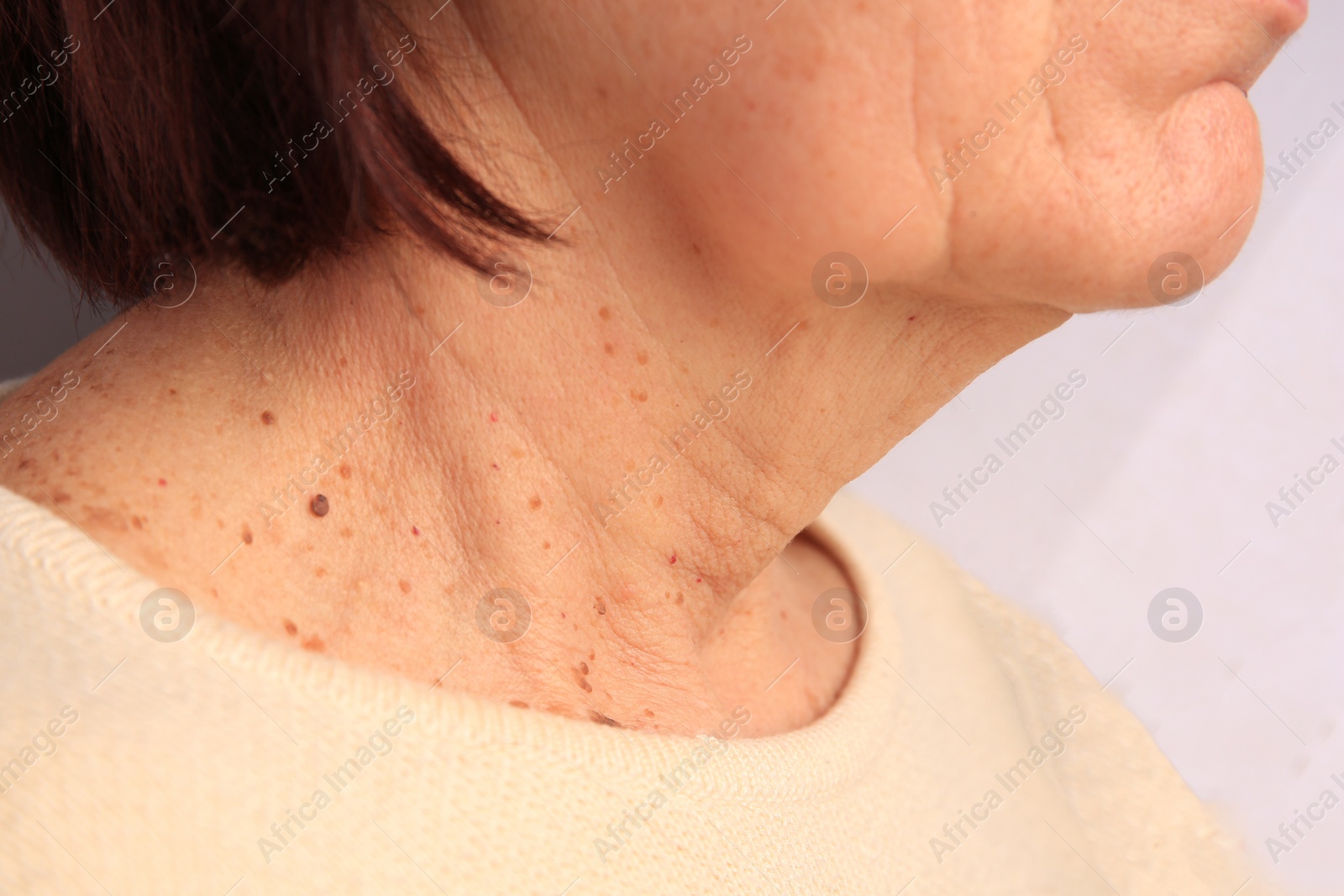 Photo of Closeup view of older woman on white background