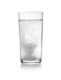 Effervescent pill dissolving in glass of water isolated on white