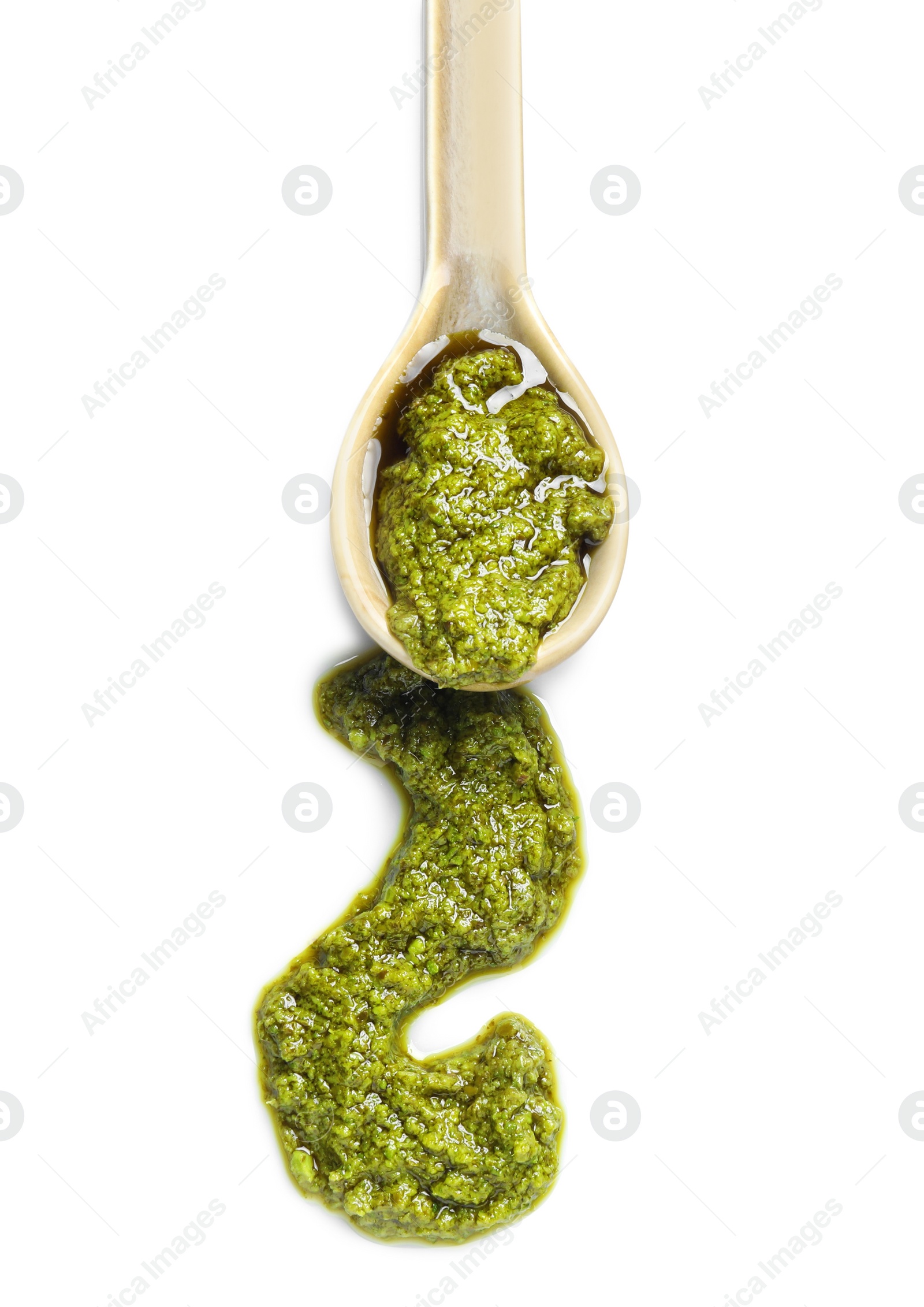 Photo of Sample of tasty pesto sauce and spoon isolated on white, top view