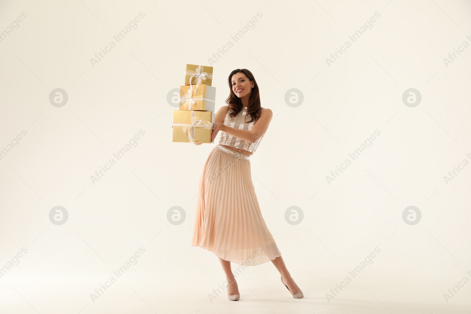 Photo of Beautiful woman with Christmas gifts on white background