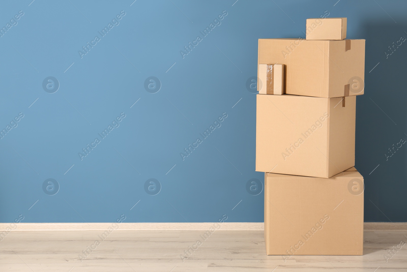 Photo of Cardboard boxes near color wall