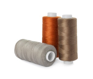 Different colorful sewing threads on white background