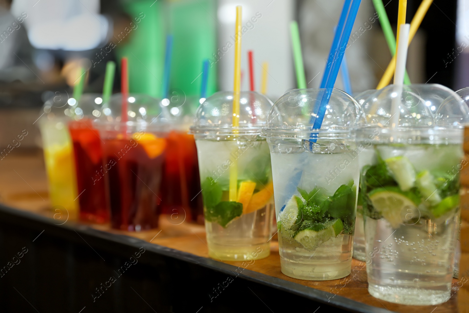 Photo of Plastic cups with refreshing drinks on bar counter