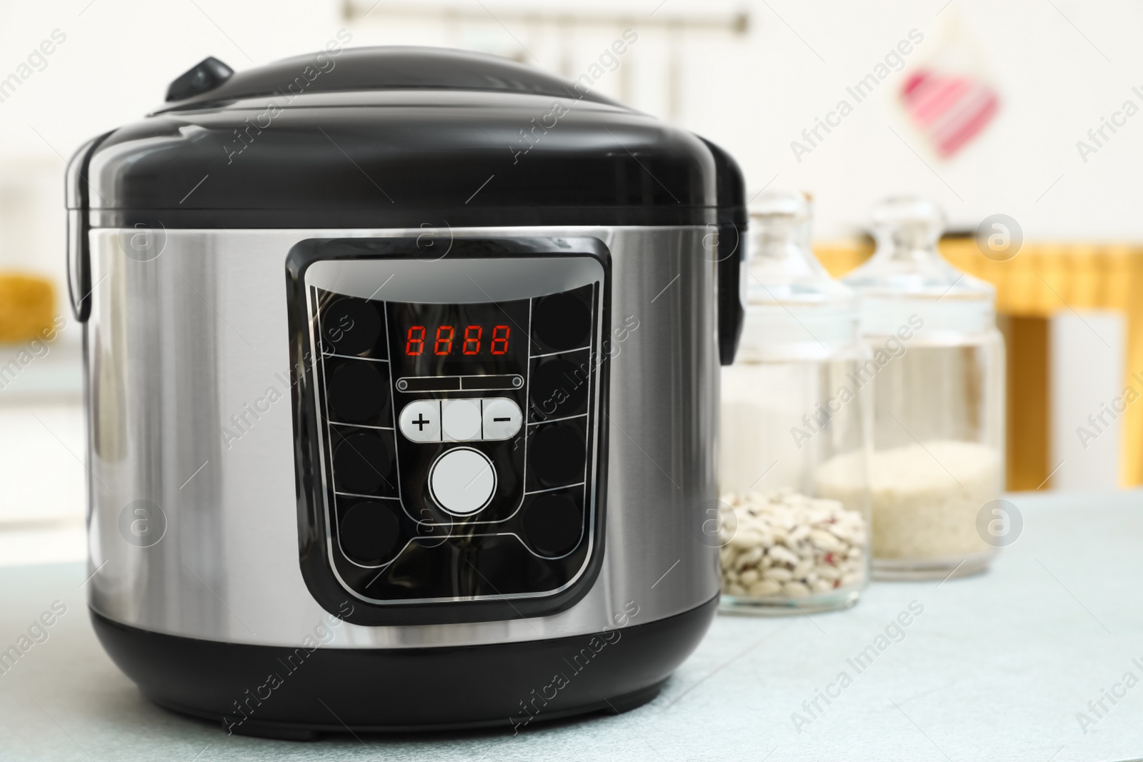 Photo of New modern multi cooker on table in kitchen