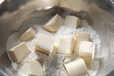 Photo of Making shortcrust pastry. Flour and butter in bowl, closeup