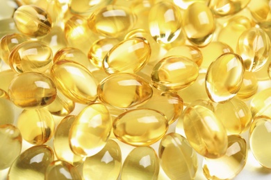 Cod liver oil pills as background, closeup