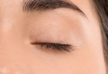 Photo of Young woman with beautiful natural eyelashes, closeup view