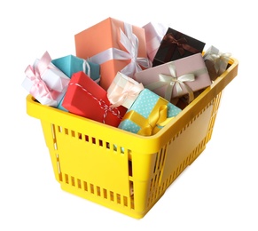 Photo of Shopping basket full of gift boxes on white background