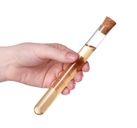 Photo of Woman holding test tube with light brown liquid on white background, closeup