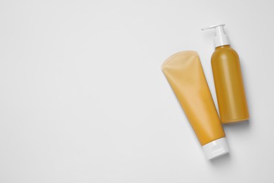 Photo of Different cleansers on white background, flat lay with space for text. Cosmetic product