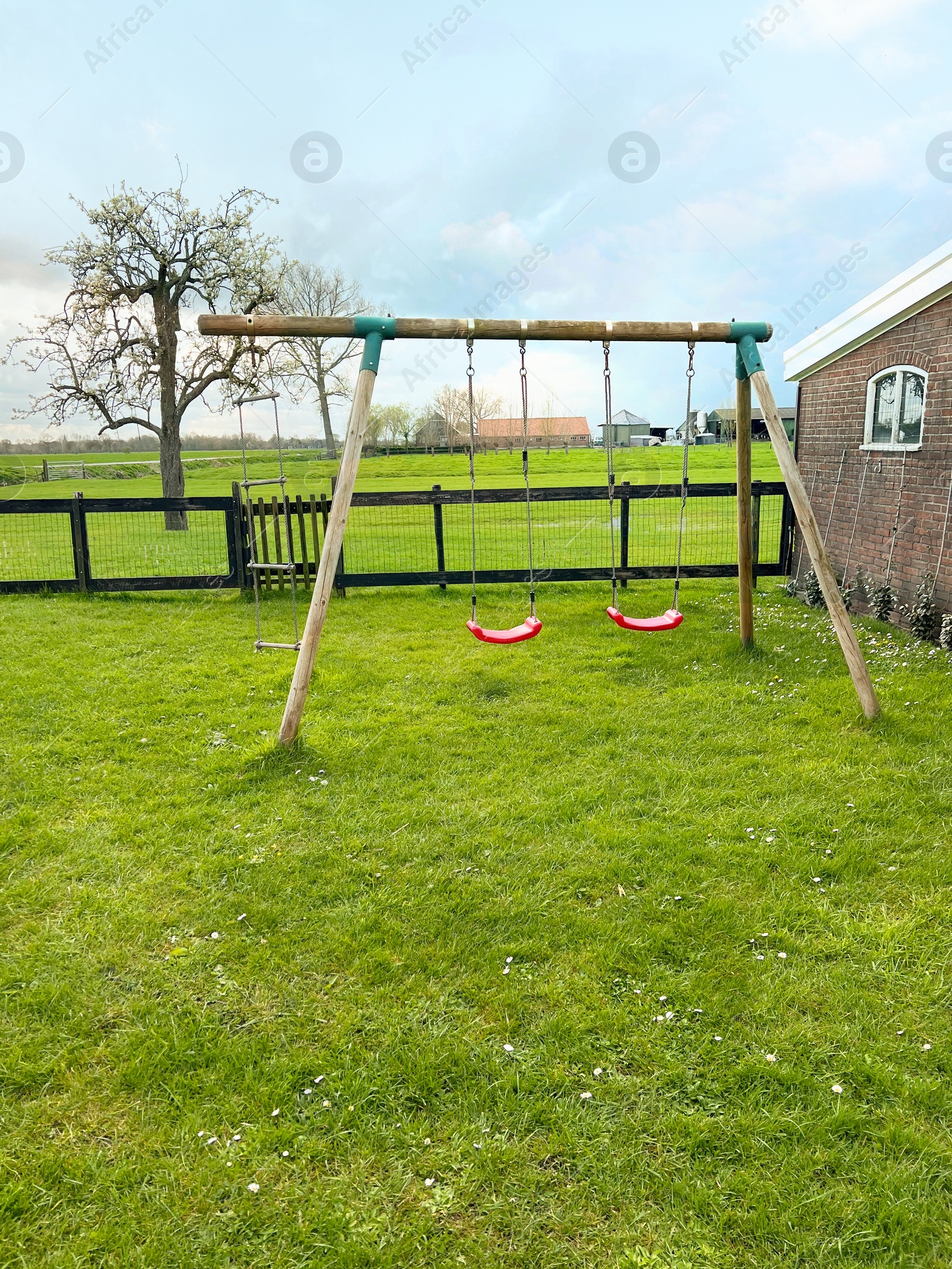 Photo of Outdoor swings near building on spring day