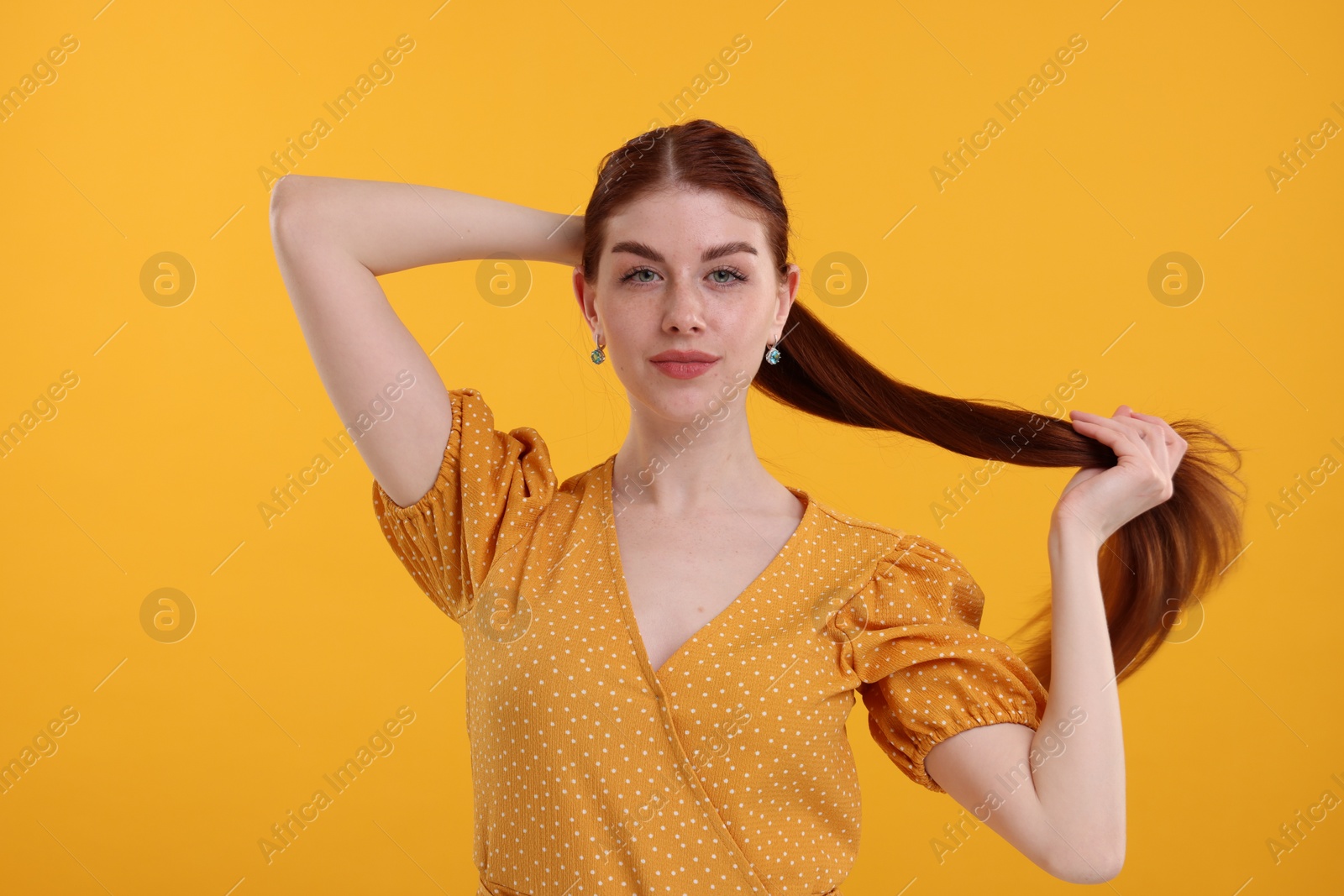 Photo of Portrait of beautiful woman on yellow background