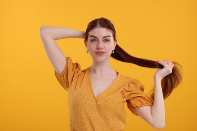 Portrait of beautiful woman on yellow background