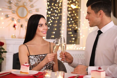 Happy couple having romantic dinner on Valentine's day in restaurant