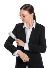 Young woman cleaning suit with lint roller on white background