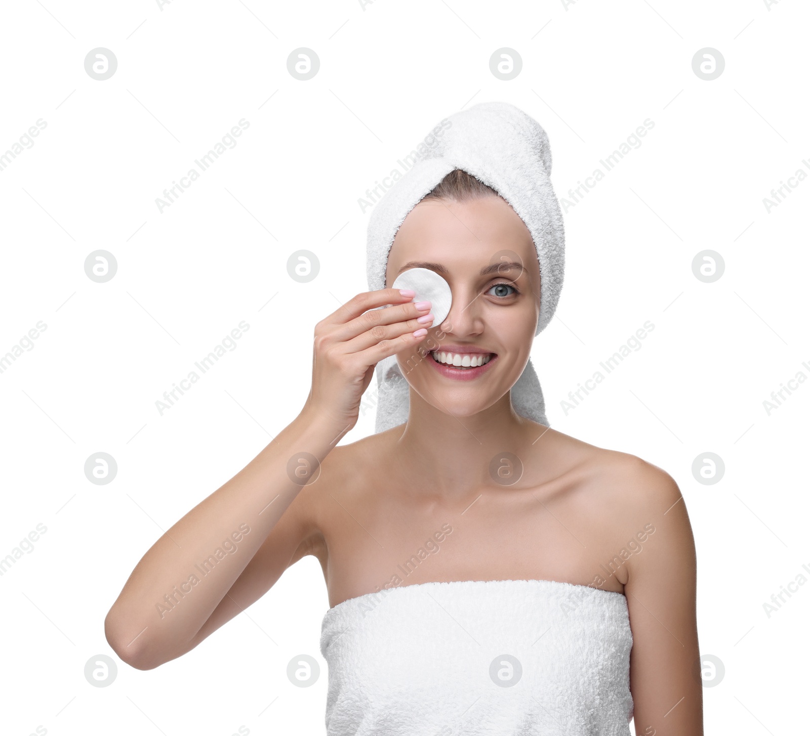 Photo of Young woman cleaning her face with cotton pad on white background