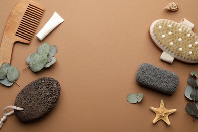 Flat lay composition with pumice stones on brown background. Space for text