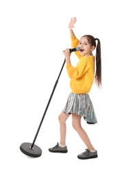 Photo of Little girl singing into microphone on white background