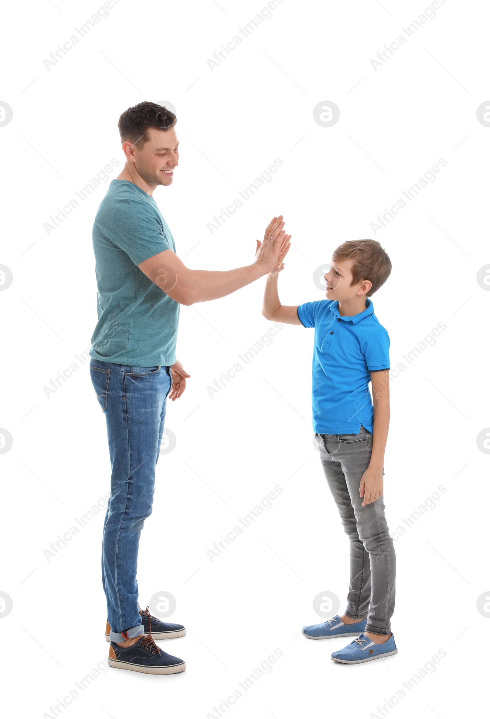 Photo of Portrait of dad and his son giving high five isolated on white