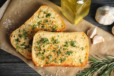 Flat lay composition with tasty garlic bread on table