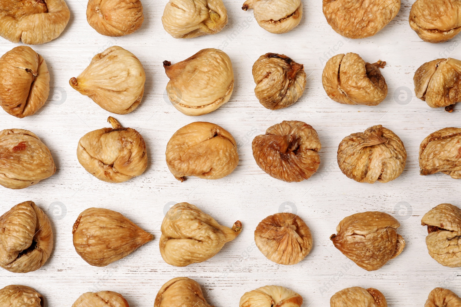 Photo of Flat lay composition with sweet figs on  wooden table. Dried fruit as healthy snack