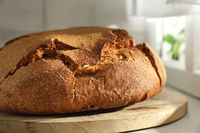 Freshly baked sourdough bread on light table, closeup