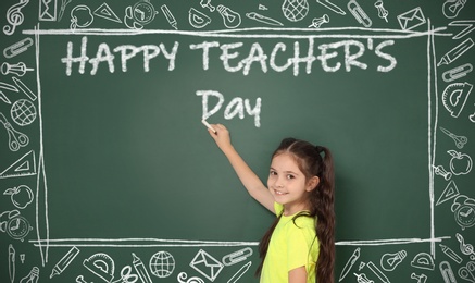 Image of Cute little girl writing phrase Happy Teacher's Day on chalkboard