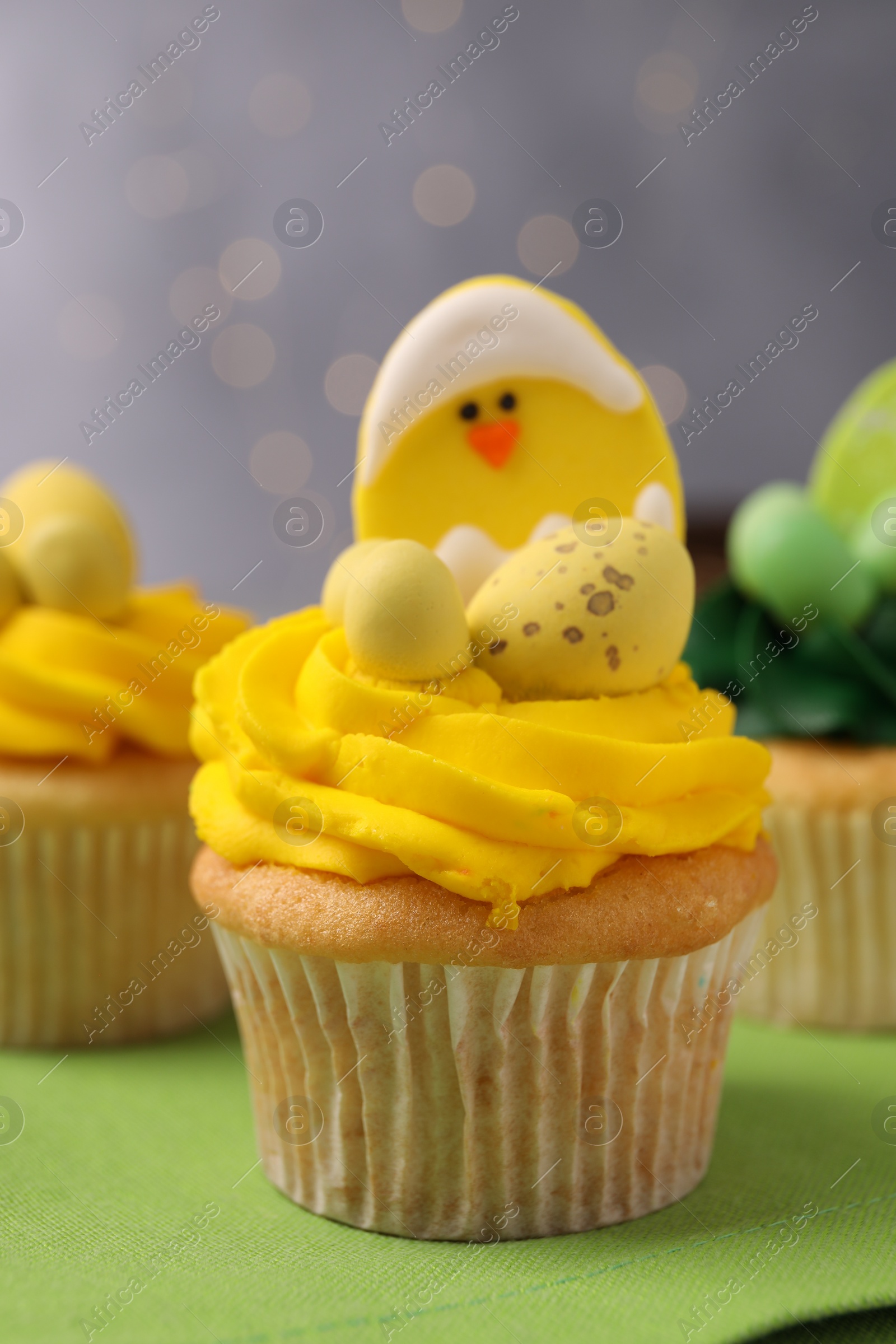 Photo of Tasty cupcakes with Easter decor on table