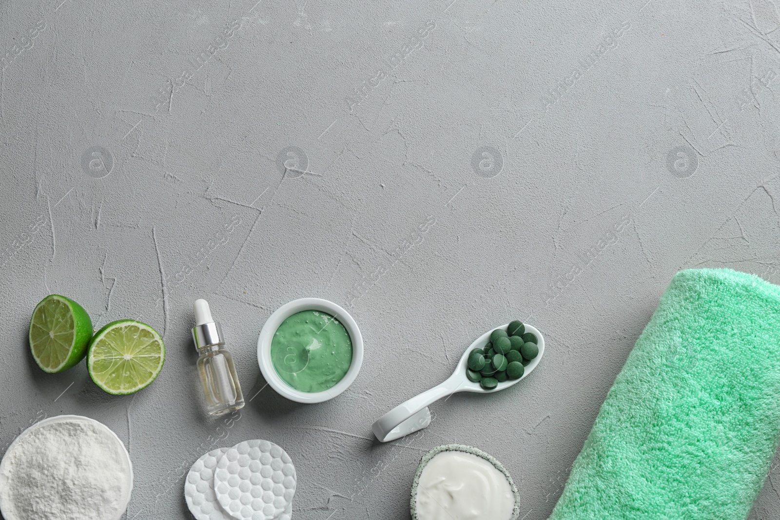 Photo of Flat lay composition with spirulina facial mask and ingredients on light grey table. Space for text