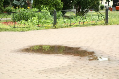 Photo of View of puddle on paving stones outdoors