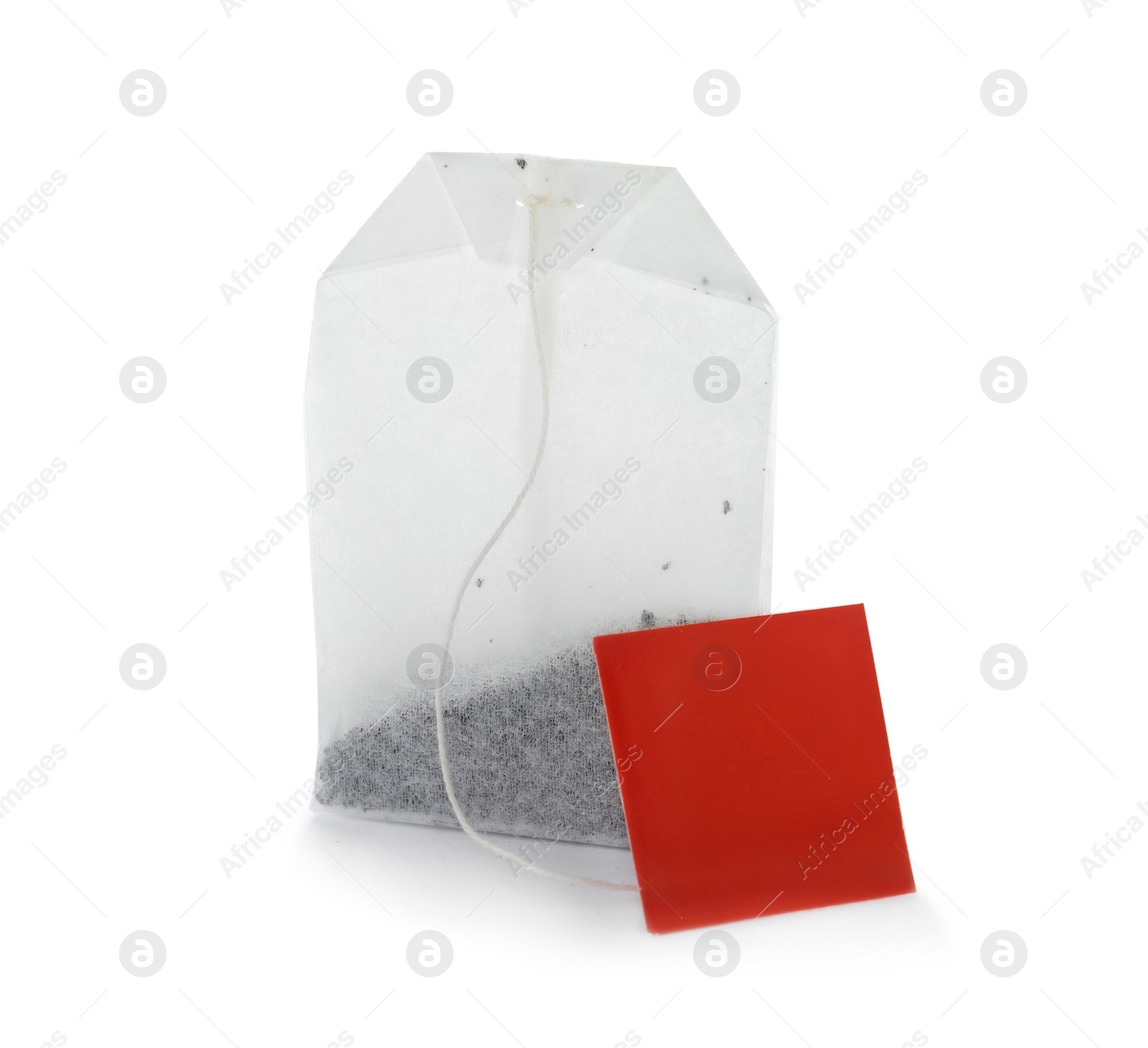 Photo of Unused tea bag with tag on white background. Space for text