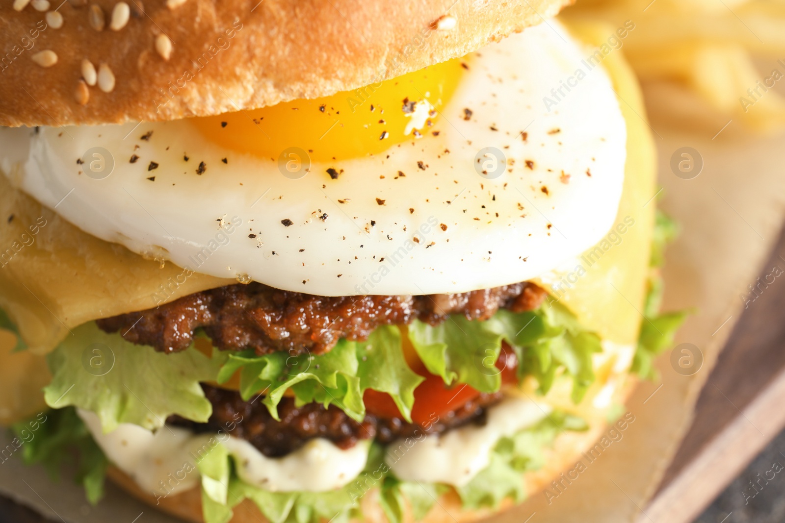 Photo of Closeup view of tasty burger with fried egg