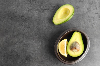 Photo of Flat lay composition with ripe avocado and lemon on grey background