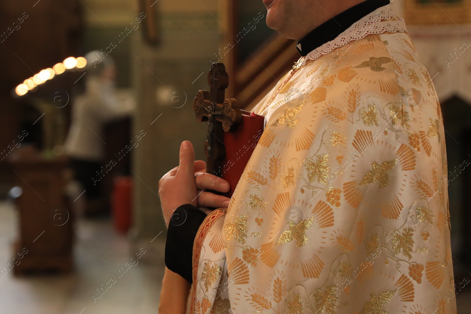 Photo of Stryi, Ukraine - September 11, 2022: Priest conducting baptism ceremony in Assumption of Blessed Virgin Mary cathedral, closeup