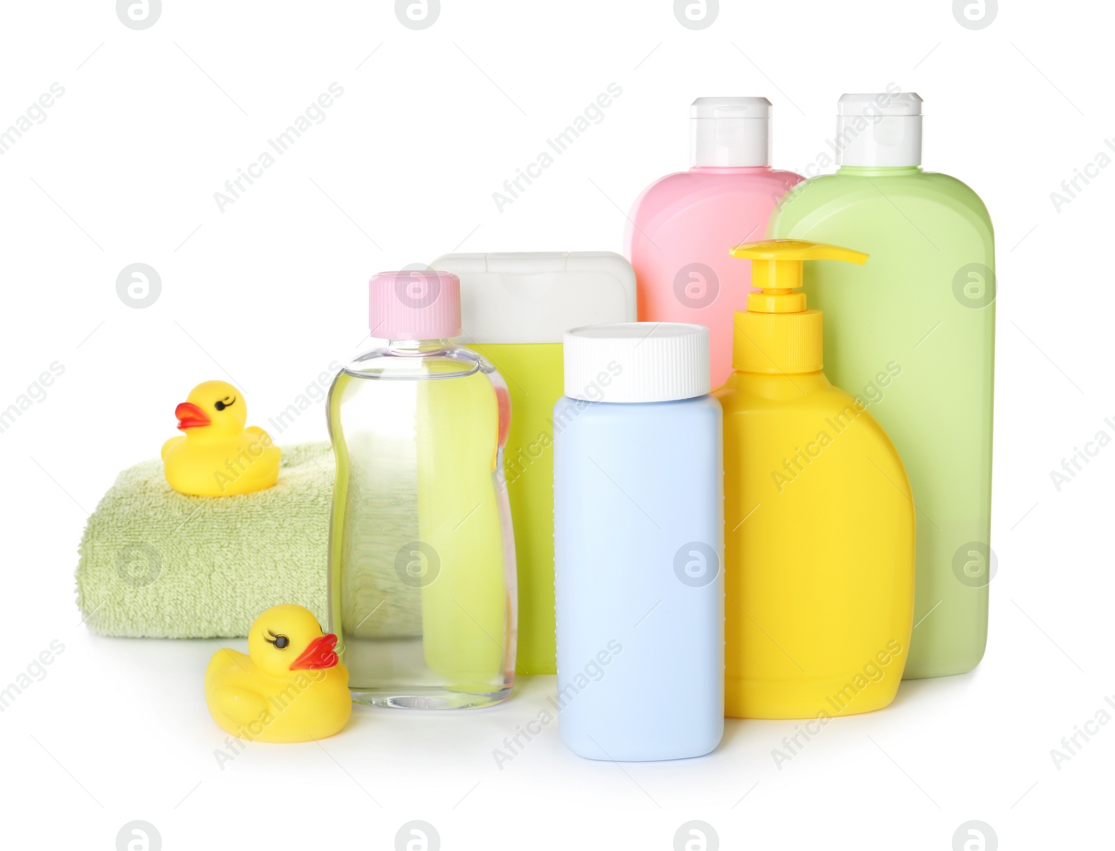 Photo of Bottles of baby cosmetic products, towel and rubber ducks on white background