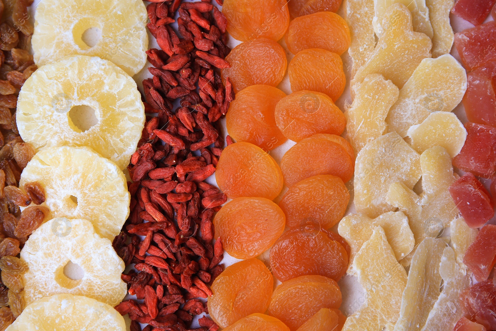 Photo of Different tasty dried fruits as background, top view