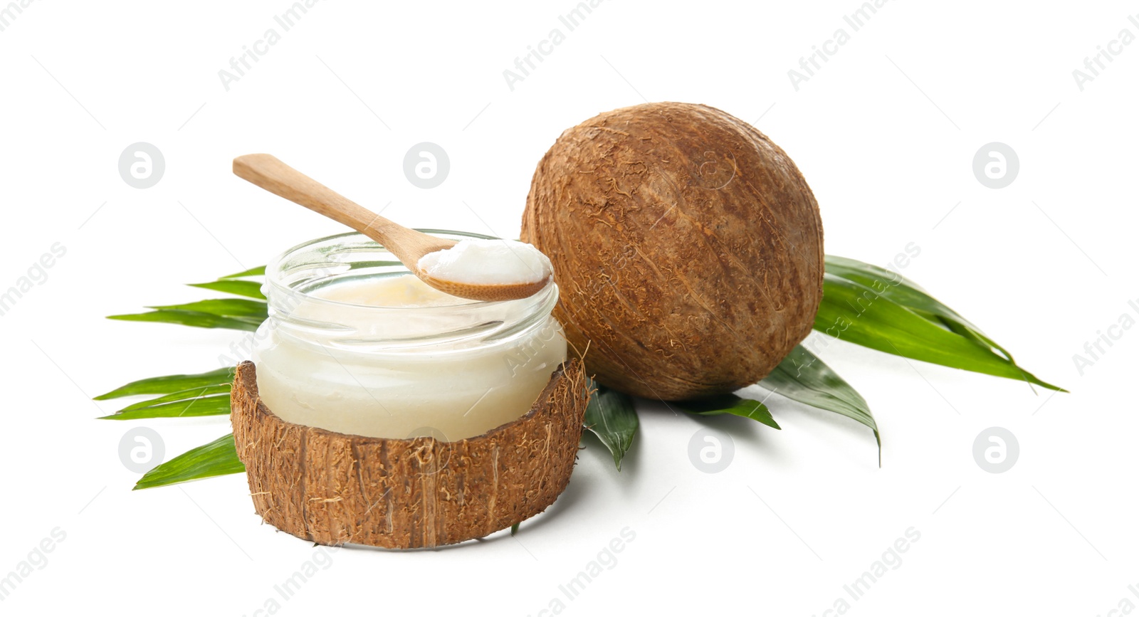 Photo of Jar with coconut oil and nut on white background