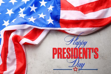 Image of Happy President's Day - federal holiday. American flag and text on grey background, top view
