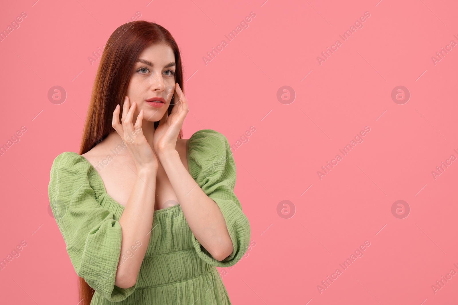 Photo of Portrait of beautiful woman with freckles on pink background. Space for text