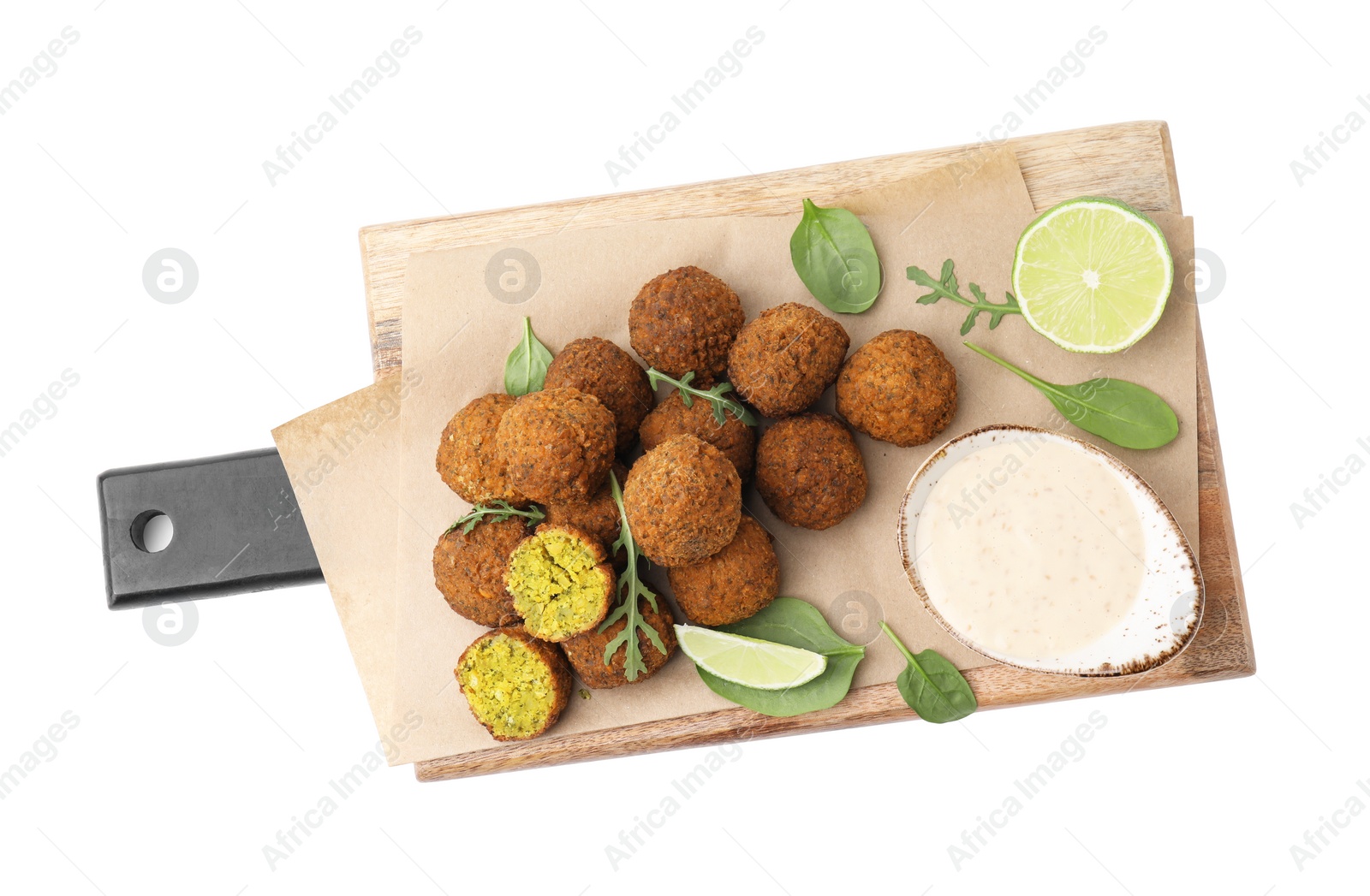 Photo of Delicious falafel balls, sauce, herbs and lime isolated on white, top view