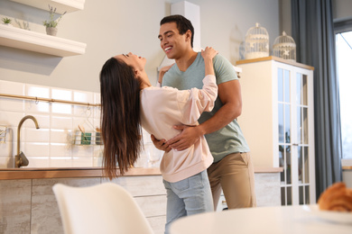 Photo of Lovely young interracial couple dancing at home