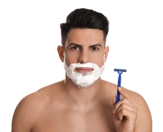 Photo of Handsome man shaving with razor on white background