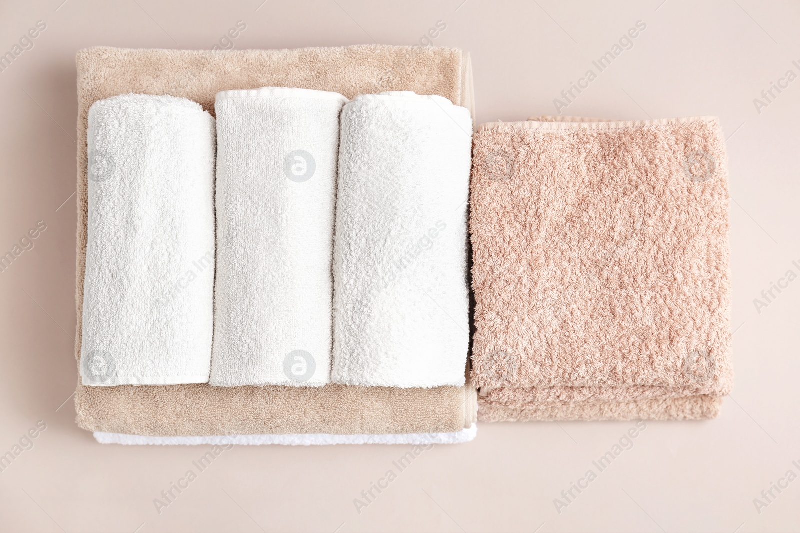 Photo of Soft bath towels on grey background, top view