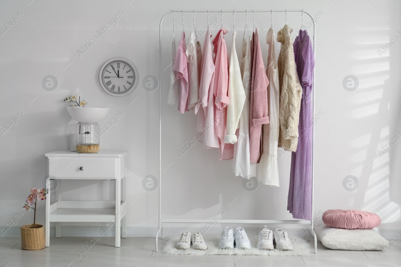 Photo of Dressing room interior with clothing rack and nightstand