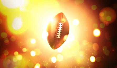 Image of Leather American ball and blurred lights on dark background 
